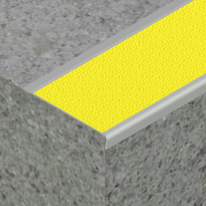 Zoomed in photo of surface mount stair nosing with a yellow insert