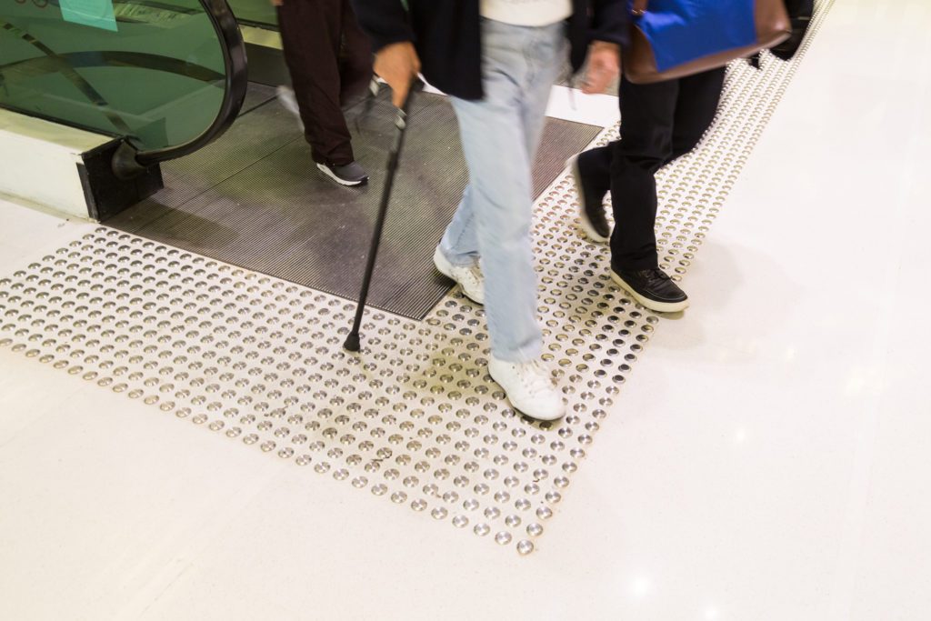 accessible infrastructure example - tactile indicators with an escalator