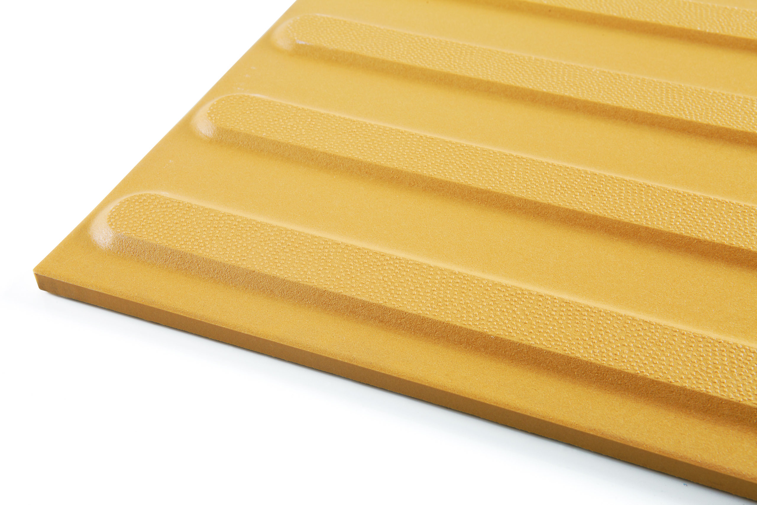 A yellow coloured ceramic directional tactile indicator