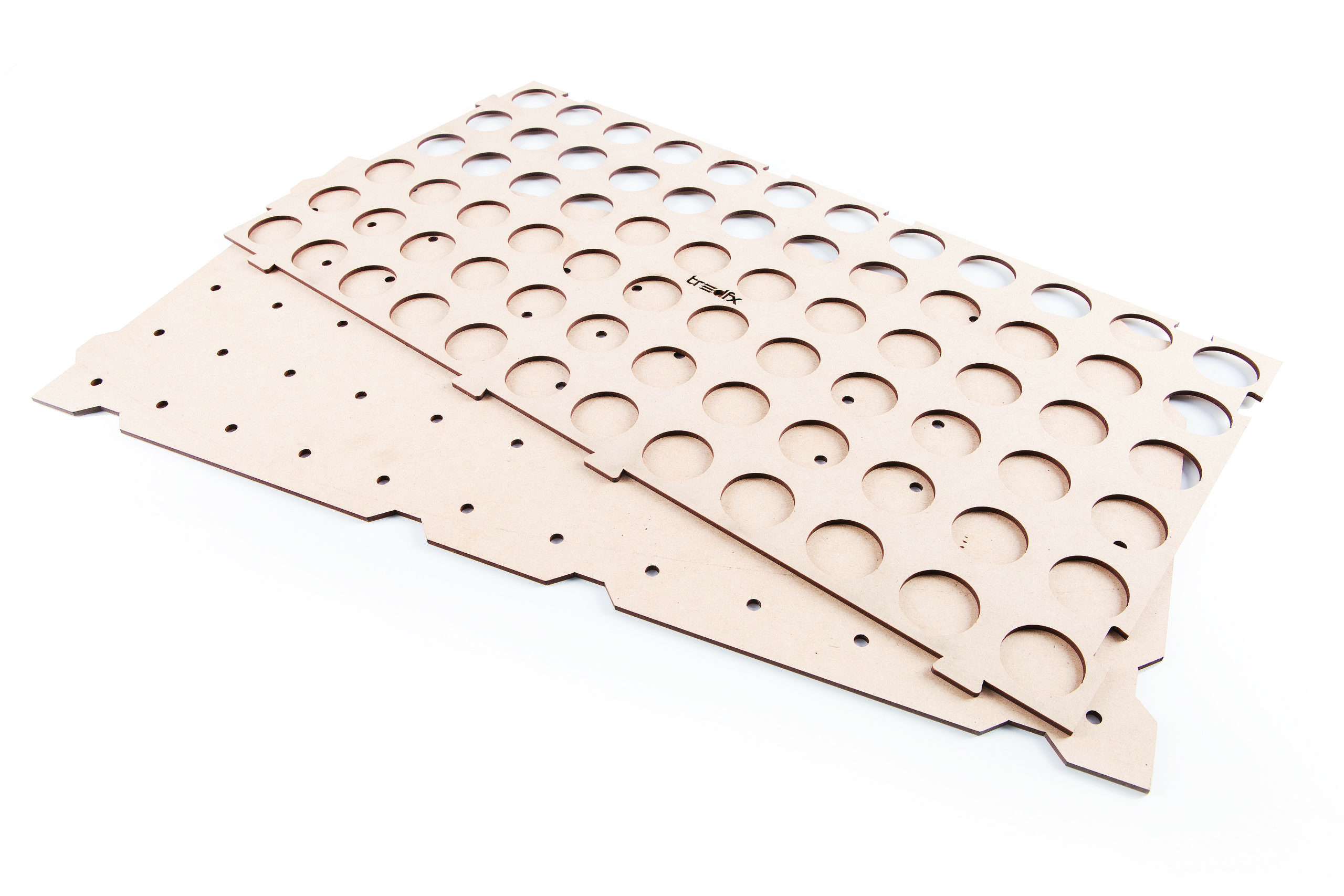 Laser-cut installation template for tactile indicators. Multiple cutouts are stacked on a white background.