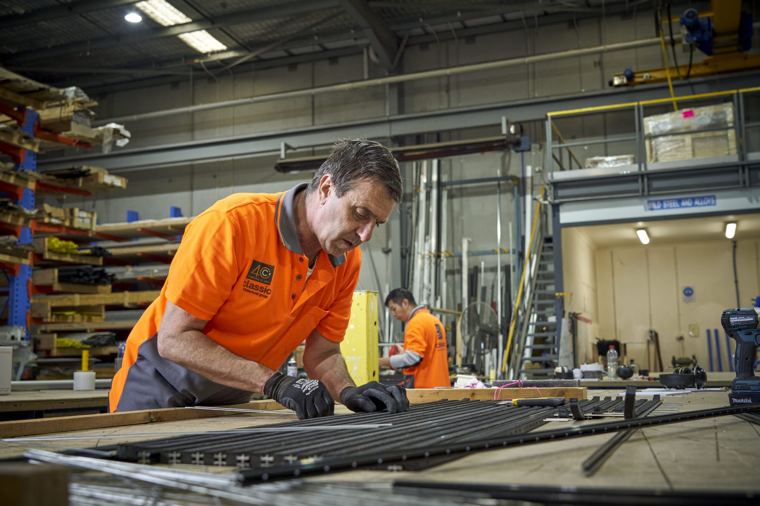 An image of staff in Classic Architectural Group's workshop working on floor trims and expansion joint covers.