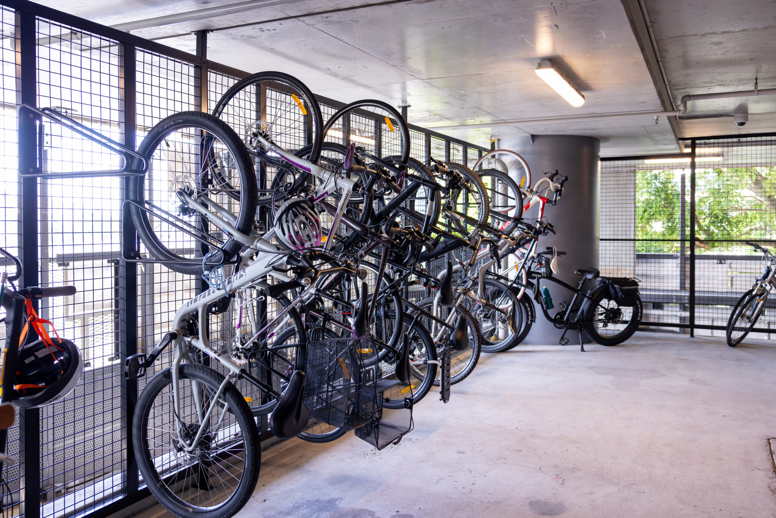 Indoor bike storage with multiple bicycles hung on a vertical bike rack installed by Classic Architectural Group at 443 Queen St, Brisbane.