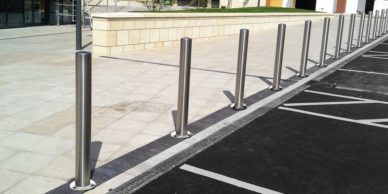 Surface-mounted stainless steel bollards installed along the length of a footpath by Classic Architectural Group.