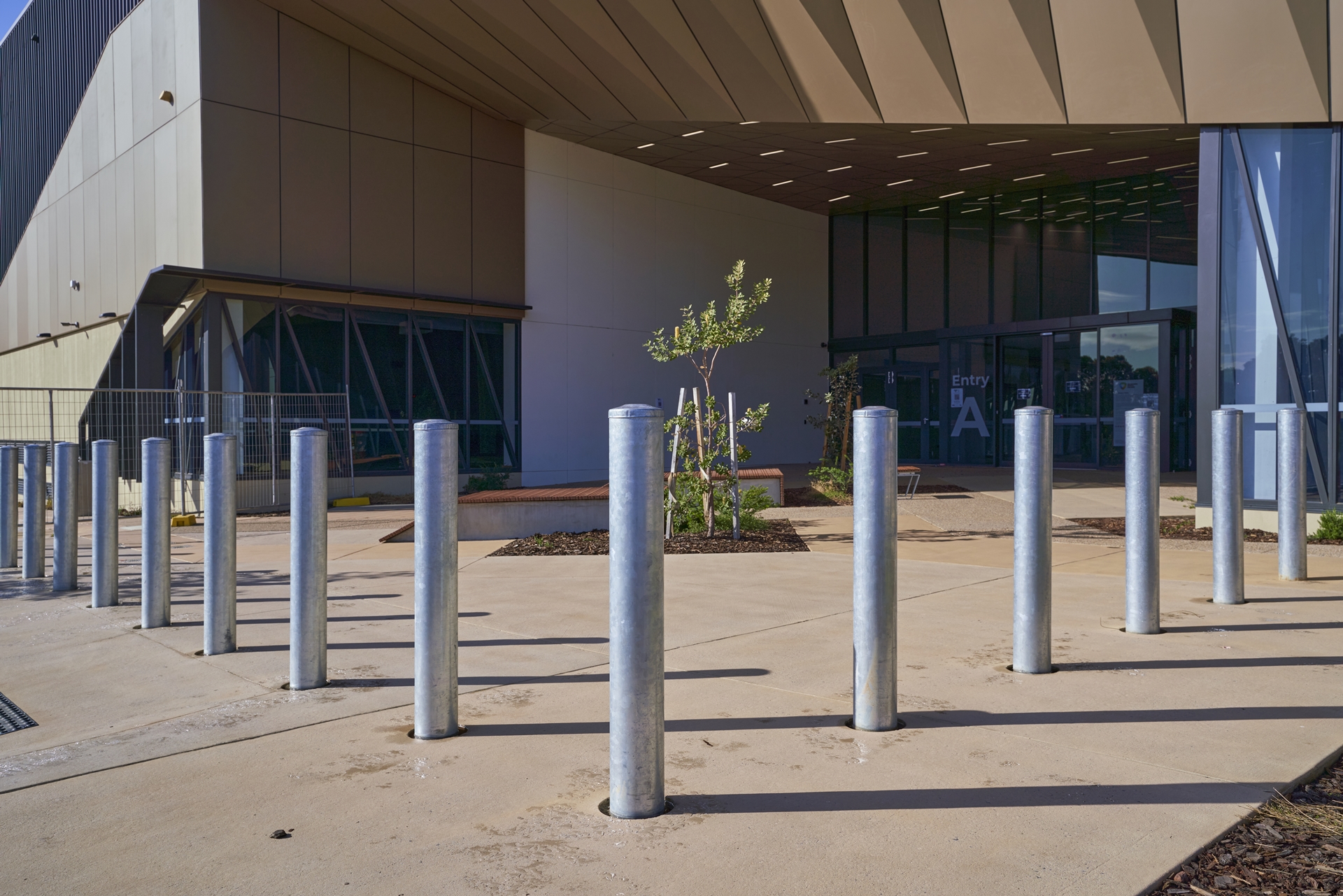 Galvanised steel bollards installed in front of a commercial building's entrance by Classic Architectural Group.